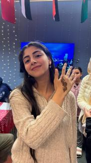 Photo of a student with henna on her hand